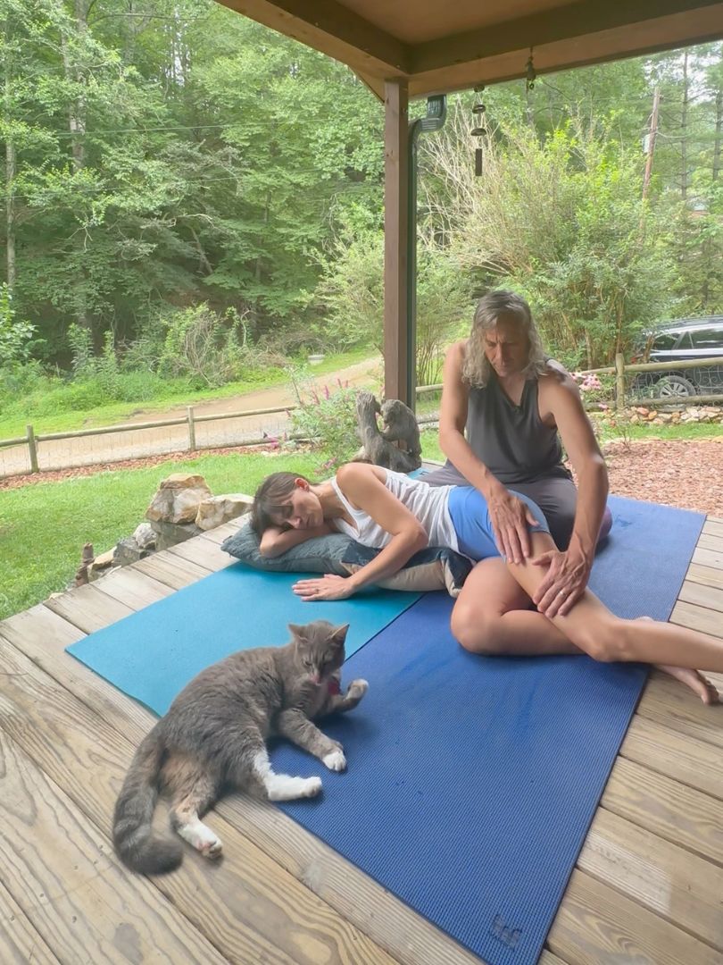Bodywork session on a wooden porch in the woods